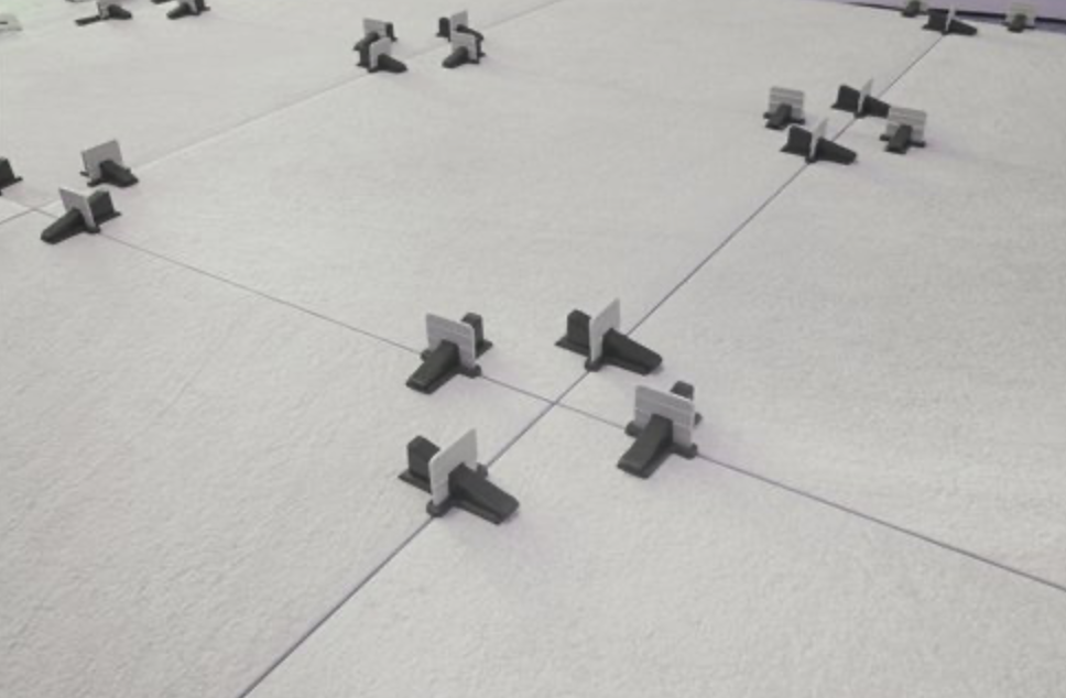 Classic leveling clips installed between floor tiles during installation